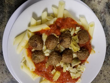 A close up picture of our meatballs and pasta dish