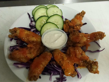 Our Spicy Buffalo Wings dish with side of cucambers and Dressing