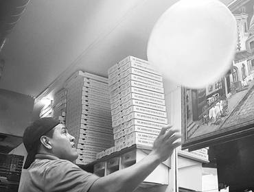 Our Chef toussing pizza dough in the air