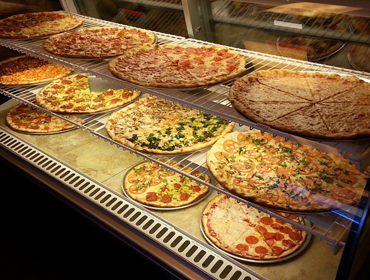 Displaing few of our specialy pizzas inside display counter.